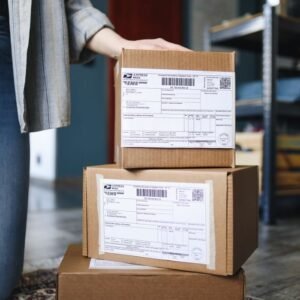 A stack of brown cardboard boxes with shipping labels ready for mail delivery.